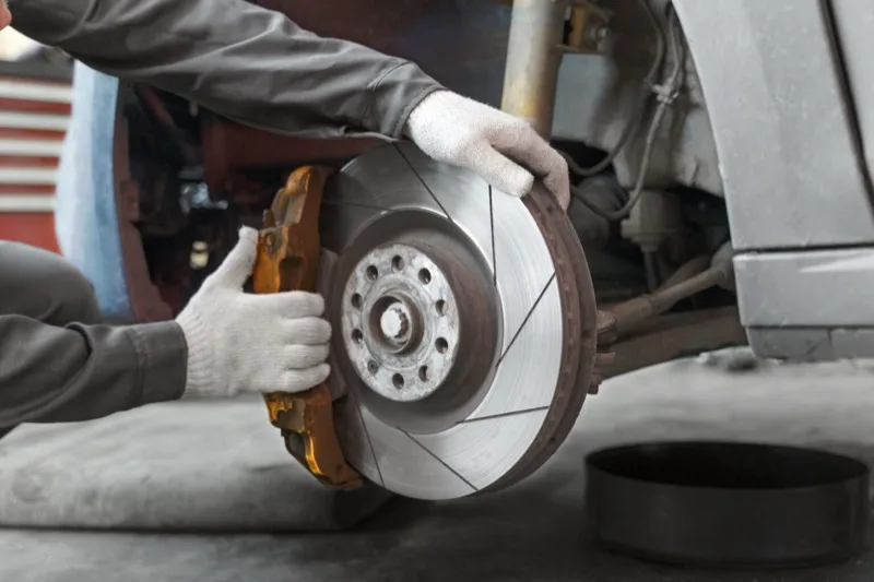 Mechanic servicing a brake rotor and caliper
